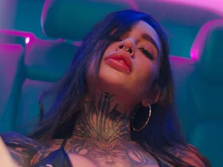 Tattooed brunette adult under neon lights, 18+